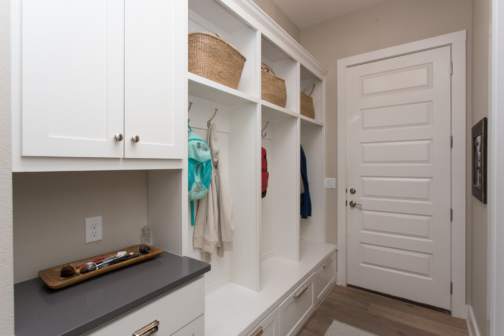 Mudroom - mid-sized transitional light wood floor and beige floor mudroom idea in Austin with beige walls and a white front door