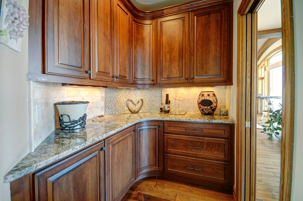 Inspiration for a mid-sized transitional medium tone wood floor eat-in kitchen remodel in Denver with an undermount sink, furniture-like cabinets, black cabinets, laminate countertops, beige backsplash, subway tile backsplash, stainless steel appliances and beige walls