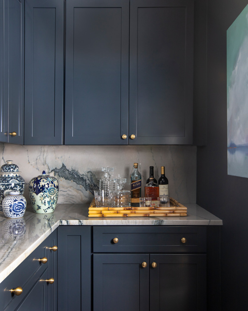 This is an example of a small transitional l-shaped wet bar in Boston with shaker cabinets, blue cabinets and marble benchtops.