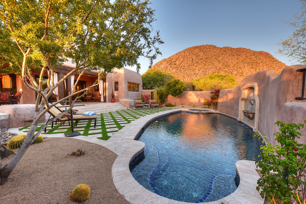 Design ideas for a custom-shaped pool in Phoenix with a hot tub and tile.