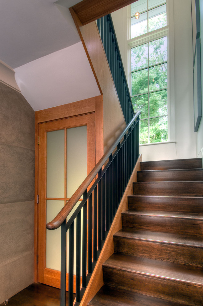 Asian wood u-shaped staircase in Boston with wood risers and metal railing.