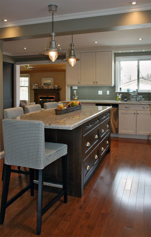 Inspiration for a large transitional l-shaped medium tone wood floor eat-in kitchen remodel in Toronto with an undermount sink, shaker cabinets, white cabinets, quartz countertops, gray backsplash, glass tile backsplash, stainless steel appliances and an island
