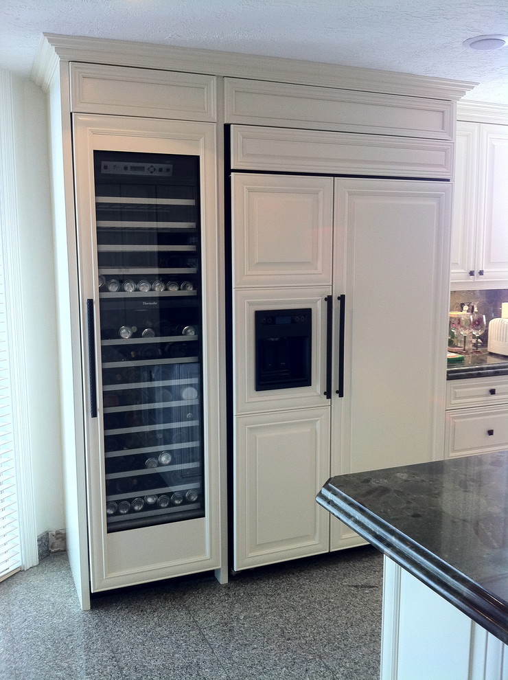Large transitional u-shaped terrazzo floor and black floor open concept kitchen photo in Miami with a single-bowl sink, raised-panel cabinets, white cabinets, granite countertops, multicolored backsplash, stone tile backsplash, stainless steel appliances and an island