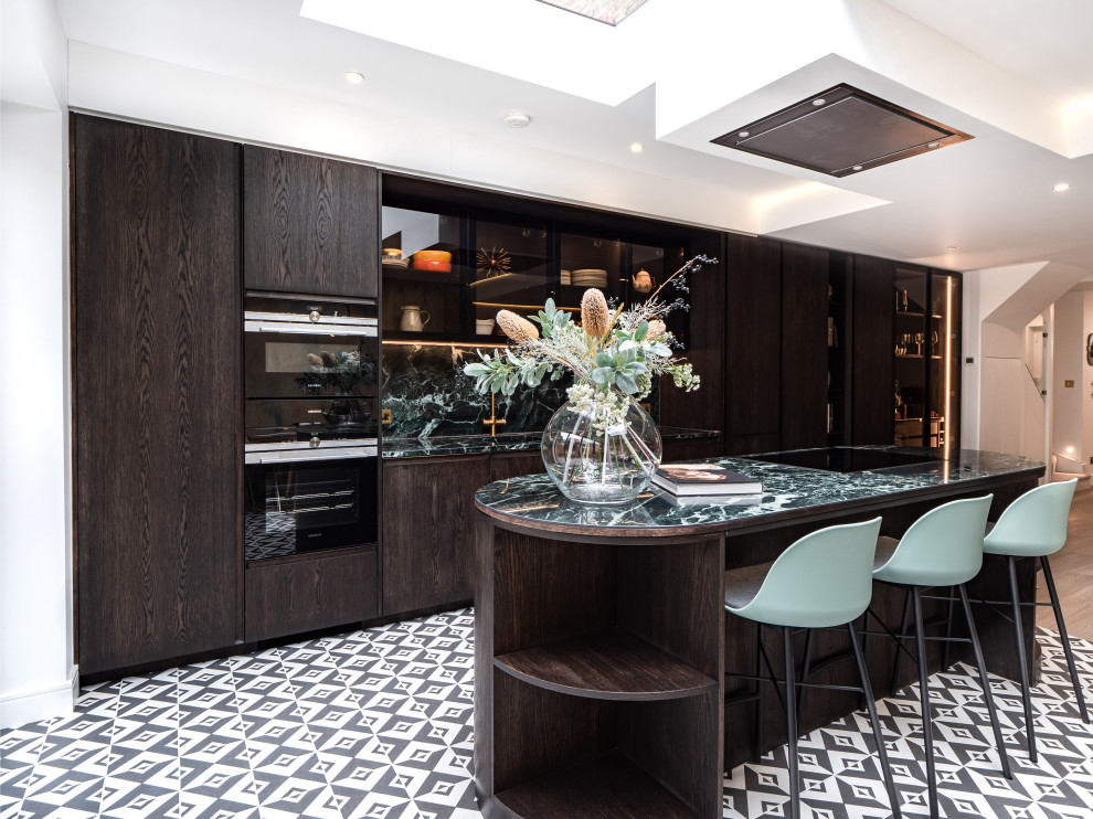Photo of a contemporary eat-in kitchen in London with with island.