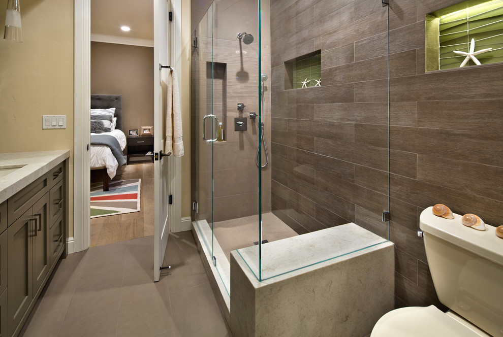 Photo of a large contemporary master bathroom in San Francisco with a corner shower, a one-piece toilet, recessed-panel cabinets and grey cabinets.