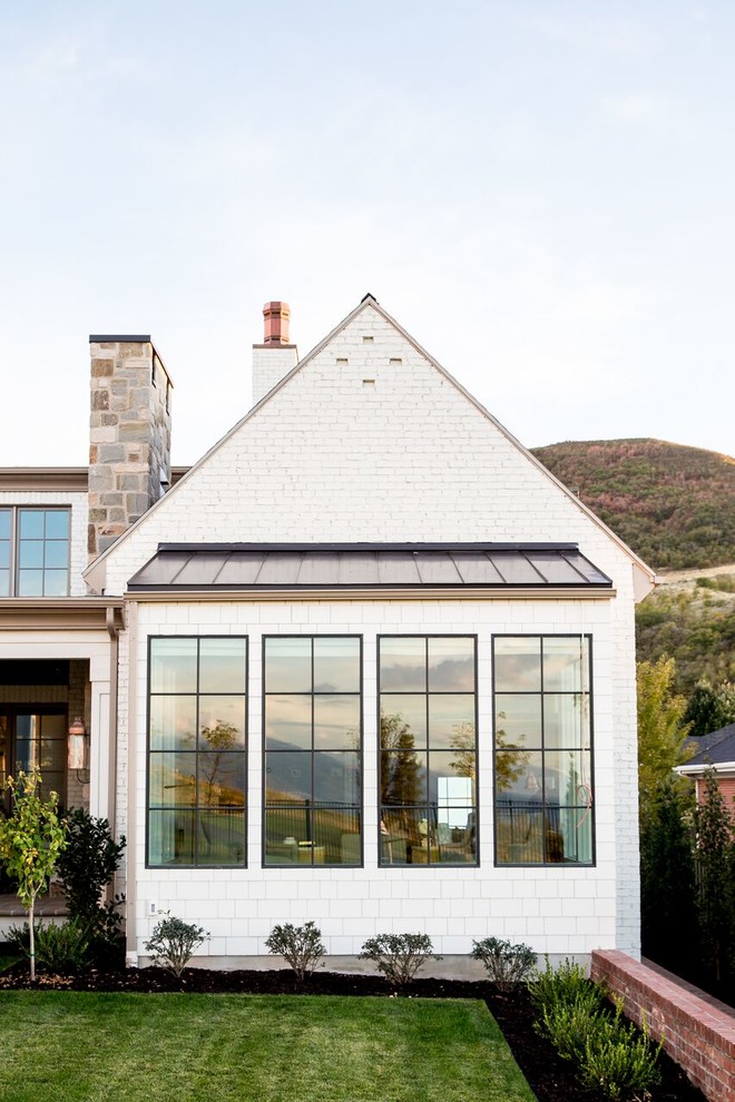 Large transitional two-storey brick white exterior in Salt Lake City with a gable roof.