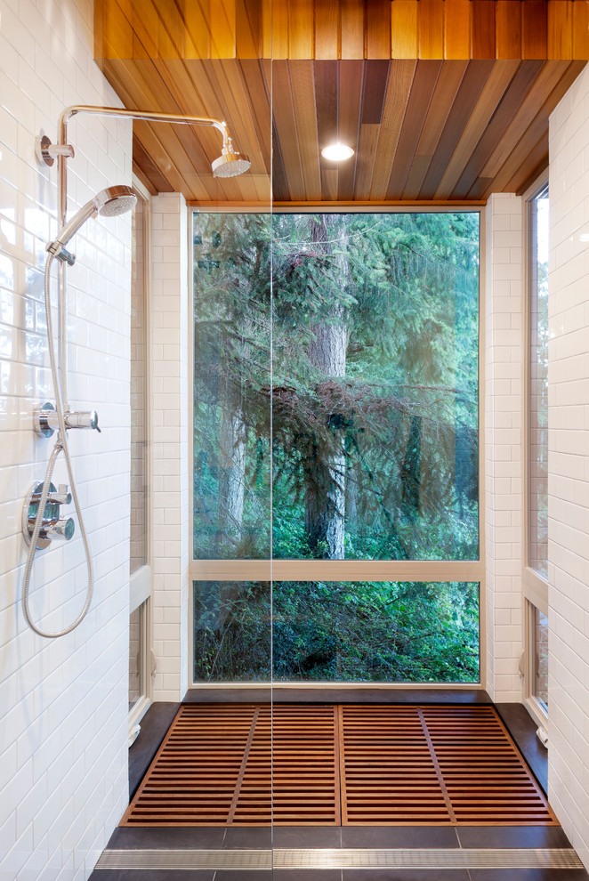 This is an example of a small contemporary master bathroom in Seattle with flat-panel cabinets, white tile, white walls, bamboo floors, a curbless shower, subway tile and an open shower.