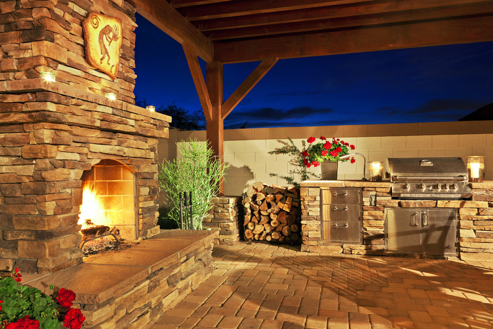 Design ideas for a large traditional backyard patio in Phoenix with a fire feature, concrete pavers and a pergola.