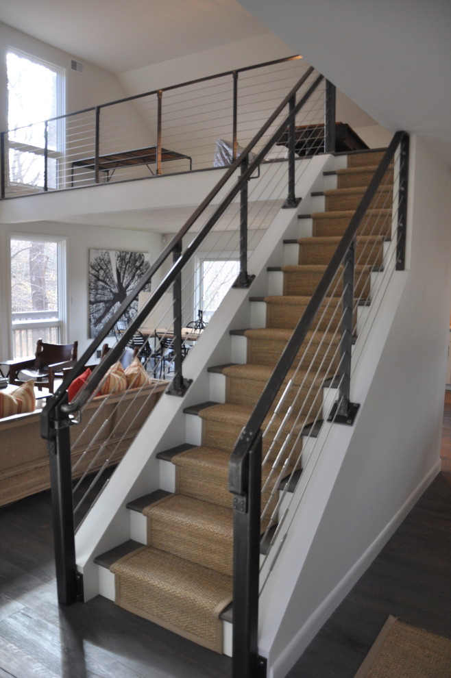 Mid-sized industrial wood straight staircase in New York with painted wood risers.
