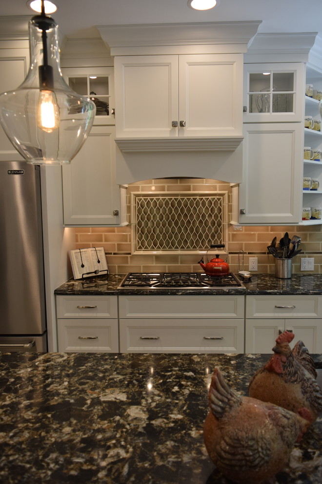 Transitional ceramic tile and gray floor kitchen photo with an undermount sink, recessed-panel cabinets, white cabinets, quartz countertops, beige backsplash, subway tile backsplash, stainless steel appliances and an island