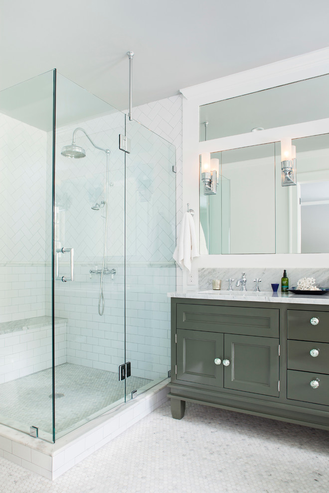 Design ideas for a mid-sized traditional master bathroom in Atlanta with an undermount sink, recessed-panel cabinets, grey cabinets, marble benchtops, a freestanding tub, a corner shower, white tile, glass tile, white walls and marble floors.