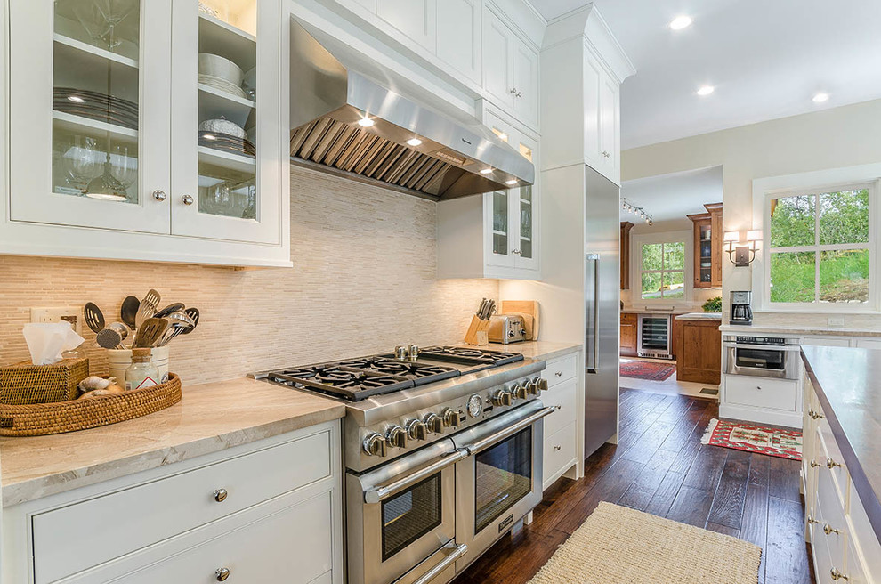 Eat-in kitchen - huge transitional l-shaped dark wood floor and brown floor eat-in kitchen idea with an undermount sink, shaker cabinets, white cabinets, wood countertops, gray backsplash, matchstick tile backsplash, stainless steel appliances and an island