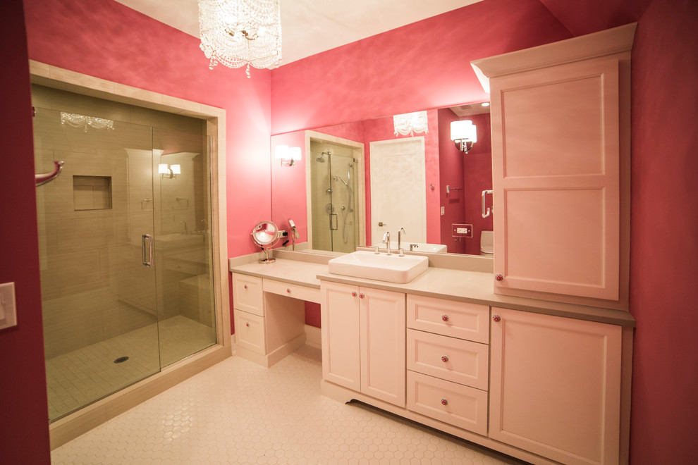 This is an example of an expansive transitional kids bathroom in Chicago with a drop-in sink, furniture-like cabinets, white cabinets, quartzite benchtops, a corner shower, a one-piece toilet, white tile, ceramic tile, pink walls and ceramic floors.