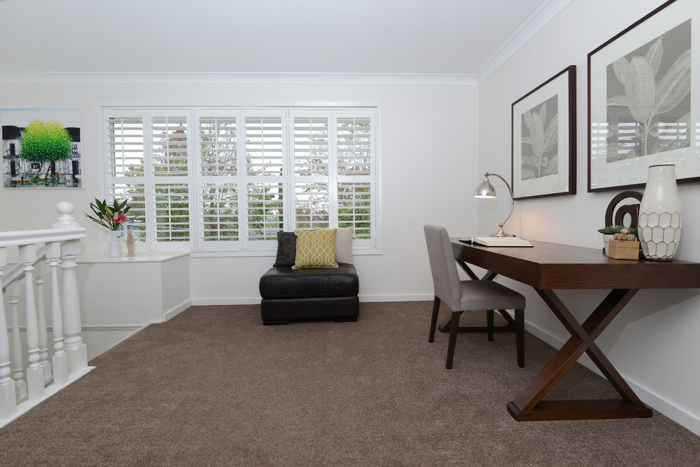 Design ideas for a transitional home office in Sydney with beige walls, carpet, no fireplace and a freestanding desk.