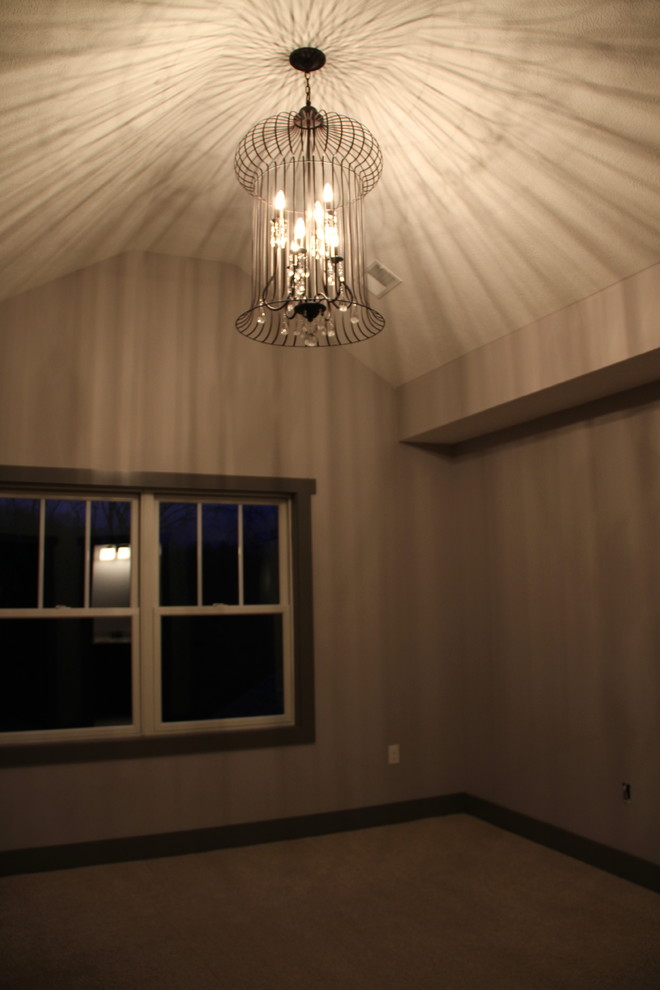 Large mountain style guest carpeted and brown floor bedroom photo with gray walls and no fireplace