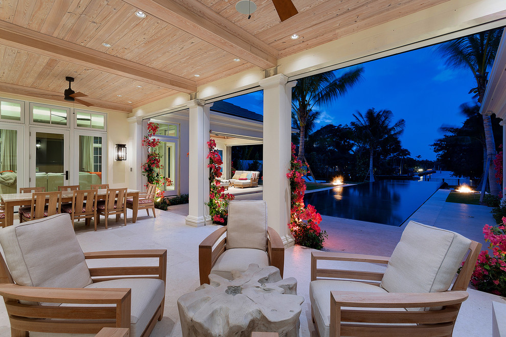 This is an example of a tropical patio in Other with a roof extension.