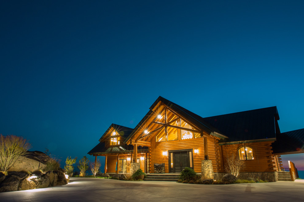 Inspiration for a huge rustic brown two-story wood exterior home remodel in Boston with a clipped gable roof