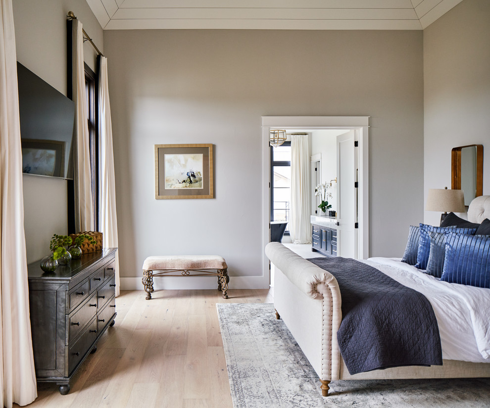 Photo of a transitional master bedroom in Other with grey walls, light hardwood floors and beige floor.