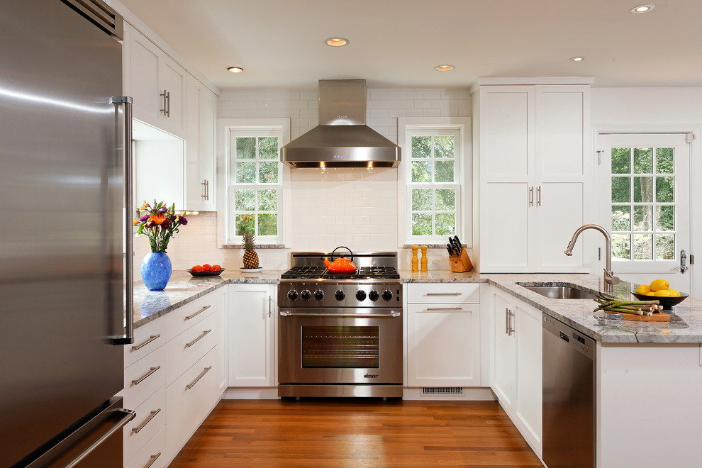 Inspiration for a small transitional u-shaped eat-in kitchen in DC Metro with an undermount sink, white cabinets, granite benchtops, white splashback, subway tile splashback, stainless steel appliances, medium hardwood floors, a peninsula and shaker cabinets.