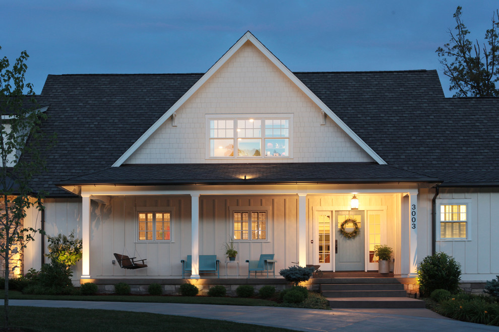 Photo of a mid-sized country two-storey white exterior in Louisville with mixed siding and a gable roof.