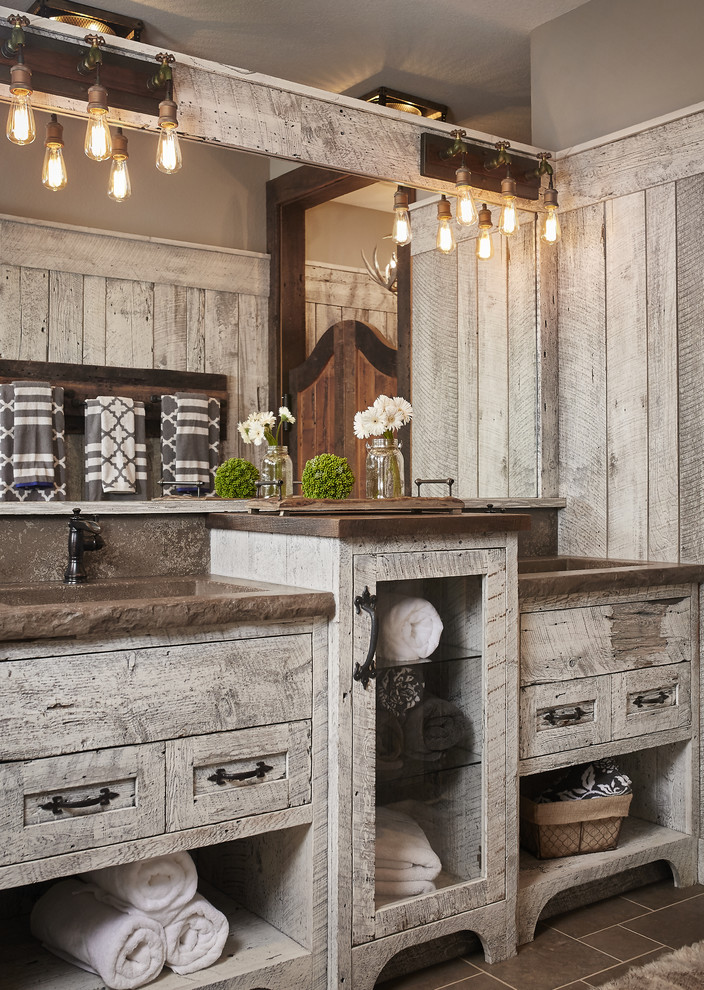 Design ideas for a country bathroom in Grand Rapids with flat-panel cabinets, distressed cabinets, grey walls and an integrated sink.