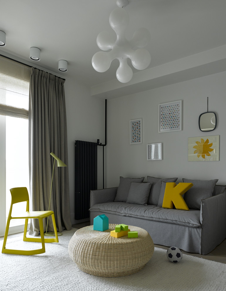 Photo of a mid-sized scandinavian kids' playroom for kids 4-10 years old and boys in Moscow with white walls, carpet and white floor.