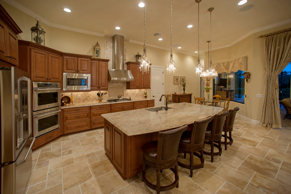 Mid-sized traditional single-wall eat-in kitchen in Tampa with an undermount sink, raised-panel cabinets, light wood cabinets, granite benchtops, beige splashback, porcelain splashback, stainless steel appliances, porcelain floors and with island.