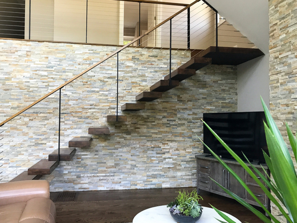 Photo of a mid-sized modern wood floating staircase in New York with open risers and cable railing.
