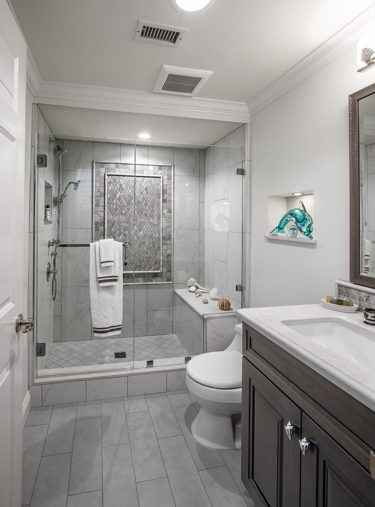 Small elegant 3/4 black and white tile and porcelain tile porcelain tile and gray floor alcove shower photo in Orange County with raised-panel cabinets, gray cabinets, a one-piece toilet, green walls, an undermount sink, quartz countertops and a hinged shower door