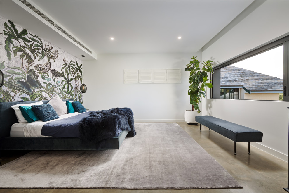 Design ideas for a large contemporary master bedroom in Perth with concrete floors, grey floor, multi-coloured walls and wallpaper.