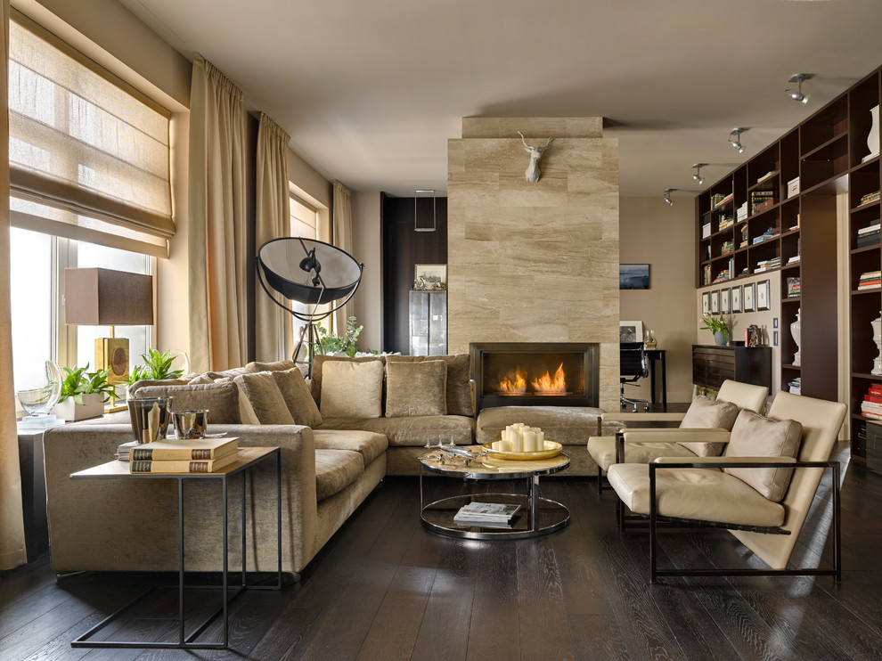 Contemporary open concept living room in Saint Petersburg with beige walls, dark hardwood floors, a standard fireplace and brown floor.
