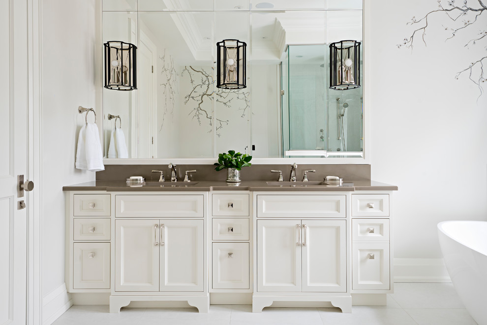 Inspiration for a large traditional master bathroom in Toronto with white walls, porcelain floors, brown benchtops, white floor, white cabinets, a freestanding tub, a corner shower, an undermount sink, engineered quartz benchtops, a hinged shower door and recessed-panel cabinets.