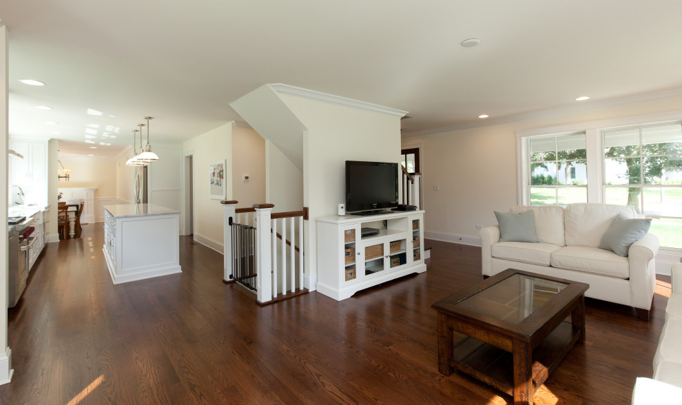 Transitional galley dark wood floor open concept kitchen photo in Chicago with a farmhouse sink, shaker cabinets, white cabinets, quartzite countertops, stainless steel appliances and an island