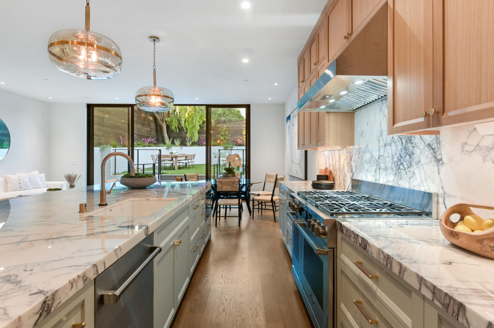Example of a large transitional medium tone wood floor open concept kitchen design in San Francisco with a single-bowl sink, recessed-panel cabinets, light wood cabinets, marble countertops, white backsplash, marble backsplash, stainless steel appliances, an island and white countertops
