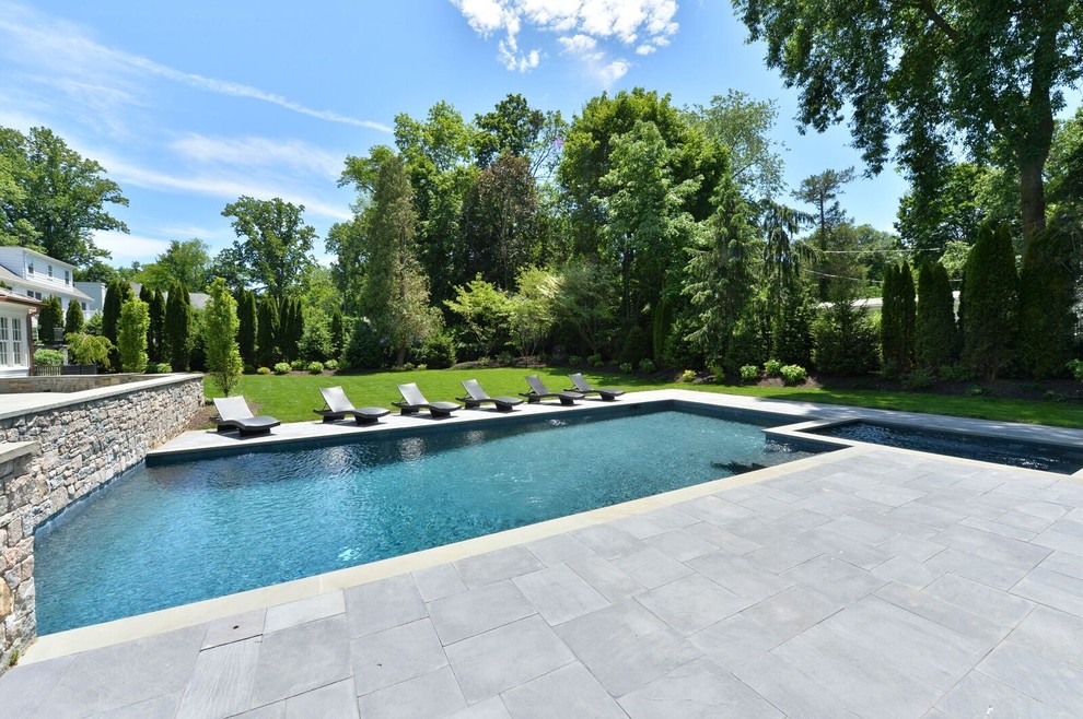 Hot tub - large transitional backyard stone and rectangular lap hot tub idea in New York