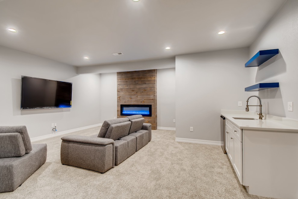 Inspiration for a medium sized contemporary fully buried basement in Denver with grey walls, carpet, a timber clad chimney breast and grey floors.