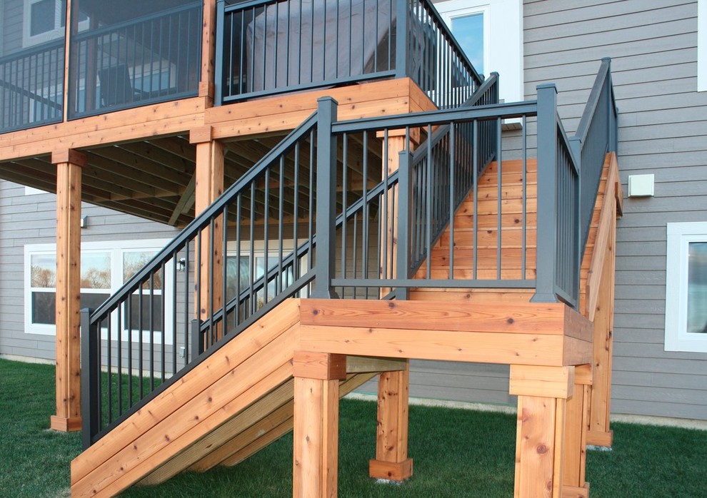 Photo of a mid-sized modern backyard deck in Other with an awning.