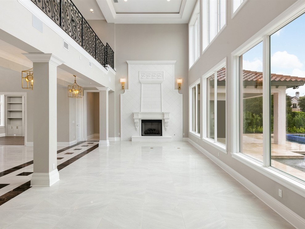 Inspiration for a large transitional formal open concept living room in Orlando with grey walls, porcelain floors, a standard fireplace, a stone fireplace surround, no tv and white floor.