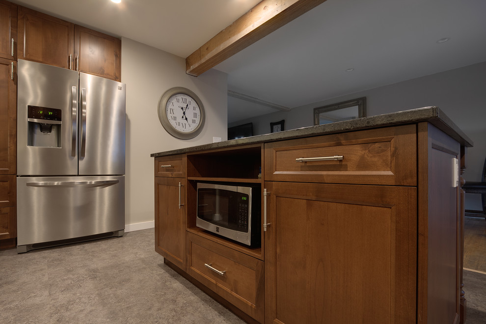 Inspiration for a mid-sized transitional kitchen remodel with shaker cabinets, medium tone wood cabinets, quartz countertops, stainless steel appliances and an island