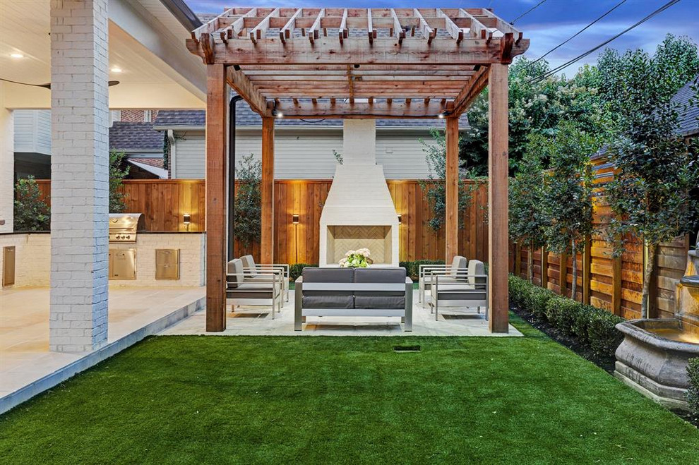 Photo of a contemporary backyard patio in Houston with with fireplace, concrete slab and a pergola.