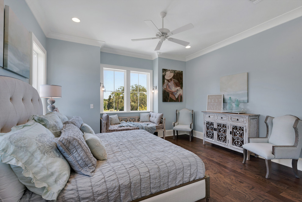 Photo of a large beach style guest bedroom in Miami with blue walls, medium hardwood floors and no fireplace.