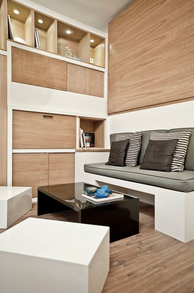 This is an example of a large contemporary open concept living room in Paris with white walls.