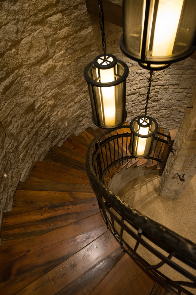 Inspiration for a large rustic wooden curved metal railing staircase remodel