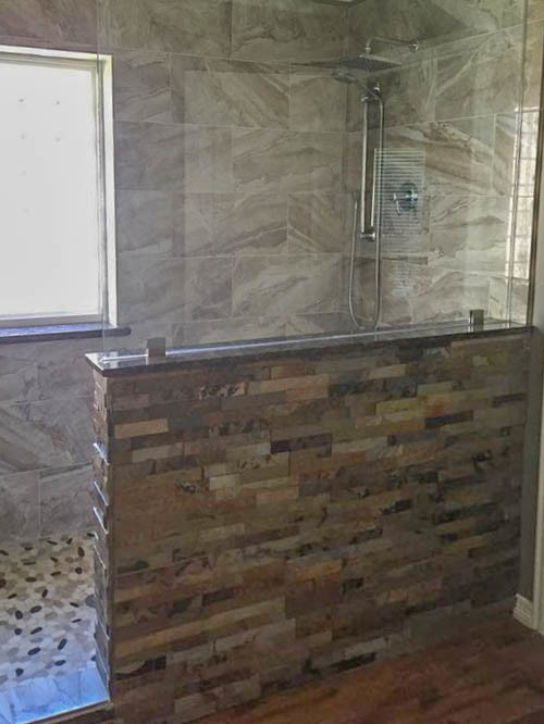 Inspiration for a mid-sized traditional master bathroom in Houston with flat-panel cabinets, white cabinets, an open shower, a one-piece toilet, multi-coloured tile, mosaic tile, multi-coloured walls, dark hardwood floors, an undermount sink, granite benchtops, brown floor and an open shower.