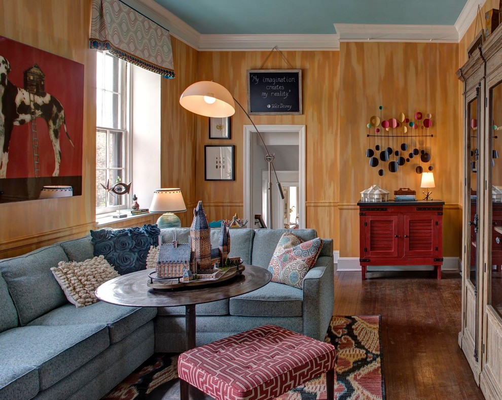 This is an example of a mid-sized eclectic enclosed family room in Baltimore with yellow walls, no fireplace, no tv and dark hardwood floors.