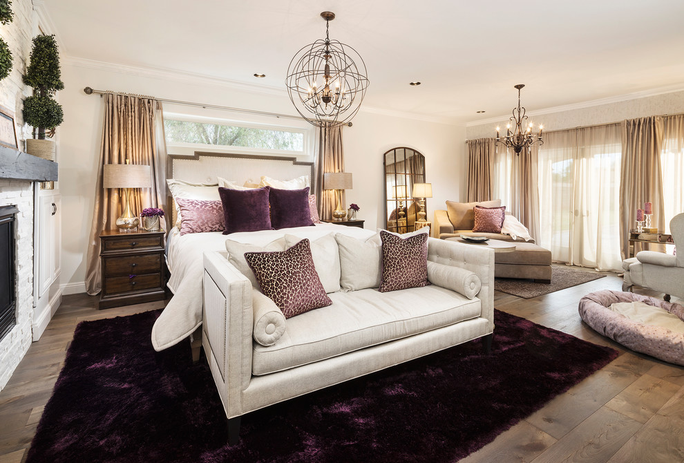 Inspiration for a large transitional master medium tone wood floor bedroom remodel in Phoenix with white walls, a standard fireplace and a stone fireplace