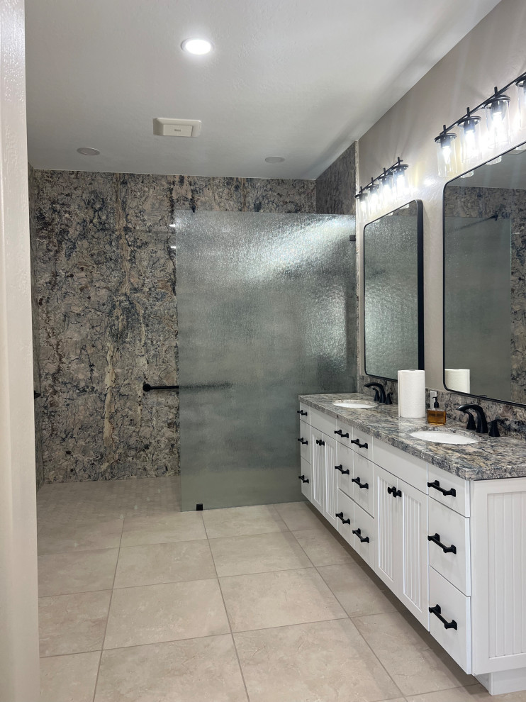 This is an example of an expansive vintage ensuite bathroom in Phoenix with white cabinets, a walk-in shower, multi-coloured tiles, stone slabs, a submerged sink, granite worktops, beige floors, an open shower, multi-coloured worktops, double sinks, a built in vanity unit and shaker cabinets.