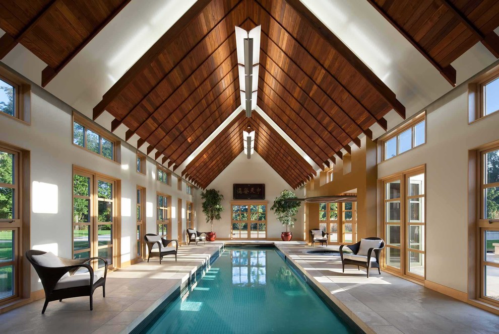 Design ideas for a large contemporary indoor rectangular lap pool in Cedar Rapids with a pool house and tile.