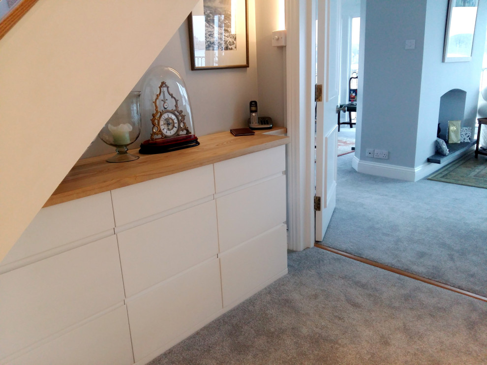 Photo of a mid-sized contemporary hallway in Cornwall with grey walls, carpet and grey floor.