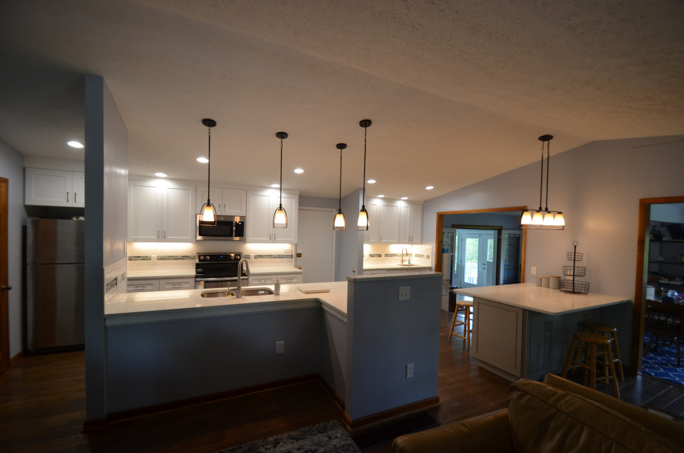 Inspiration for a mid-sized transitional u-shaped porcelain tile and beige floor eat-in kitchen remodel with an undermount sink, raised-panel cabinets, beige cabinets, granite countertops, stainless steel appliances, an island and multicolored countertops